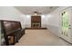 Living room showing brick fireplace and door to the outside with a wooden bench at 104 Argyle Ct, Garner, NC 27529
