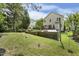Large backyard with a built-in grilling area, a tiered fountain, and a large manicured lawn at 104 Caley Rd, Apex, NC 27502