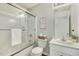 Clean bathroom with a glass-enclosed shower, white vanity, decorative mirror, and ample counter space at 104 Caley Rd, Apex, NC 27502