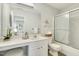 Bathroom featuring a glass-enclosed shower, vanity with white countertop, and stylish decor at 104 Caley Rd, Apex, NC 27502