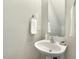 Stylish powder room featuring a pedestal sink, chrome fixtures, and neutral wall color at 104 Caley Rd, Apex, NC 27502