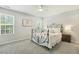Cozy bedroom with carpet, ceiling fan, and decorative iron bed frame at 104 Caley Rd, Apex, NC 27502