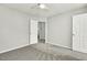 Neutral bedroom with carpeting, ceiling fan, closet, and ample natural light at 104 Caley Rd, Apex, NC 27502