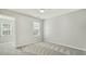 Bedroom with plush carpeting, neutral walls, and window letting in natural light at 104 Caley Rd, Apex, NC 27502