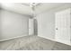 Neutrally decorated bedroom with plush carpeting, ample natural light, and a ceiling fan at 104 Caley Rd, Apex, NC 27502