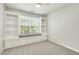 Bedroom featuring custom built-in bookshelves and a window seat, perfect for reading and relaxing at 104 Caley Rd, Apex, NC 27502