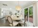 Bright dining room area with patio access and modern light fixture at 104 Caley Rd, Apex, NC 27502