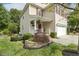 Charming two-story home with inviting entrance, landscaped yard, and a well-manicured lawn at 104 Caley Rd, Apex, NC 27502