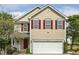 Charming two-story home with a well-manicured lawn, inviting entrance, and red shutters at 104 Caley Rd, Apex, NC 27502
