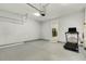 Spacious garage featuring clean floors, utility hook ups and ample storage area, plus home gym at 104 Caley Rd, Apex, NC 27502