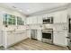 Updated kitchen features stainless steel appliances and white subway tile backsplash at 104 Caley Rd, Apex, NC 27502