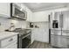 Gourmet kitchen with stainless steel appliances and ample counter space at 104 Caley Rd, Apex, NC 27502