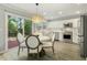 Eat-in kitchen offers stainless appliances, white cabinets, and breakfast nook at 104 Caley Rd, Apex, NC 27502