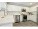Bright kitchen with stainless steel appliances and modern white cabinetry at 104 Caley Rd, Apex, NC 27502