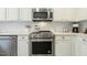 Close-up of stainless steel oven and microwave in a white kitchen at 104 Caley Rd, Apex, NC 27502