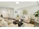 Comfortable living room boasts neutral tones and wood-look flooring at 104 Caley Rd, Apex, NC 27502