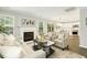 Bright living room with neutral furniture, fireplace, and an open layout to the kitchen at 104 Caley Rd, Apex, NC 27502