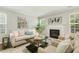 Bright living room featuring a fireplace and neutral furniture at 104 Caley Rd, Apex, NC 27502
