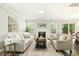Bright living room with neutral furniture, fireplace, and an open layout at 104 Caley Rd, Apex, NC 27502