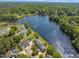Aerial view of community homes along a pretty lake surrounded by mature trees and lush landscaping at 105 Breakers Pl, Cary, NC 27511