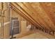 Unfinished attic featuring exposed rafters and beams providing ample storage space at 105 Breakers Pl, Cary, NC 27511