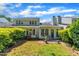 A backyard with a small brick patio is overlooked by the home's many windows and surrounded by trimmed hedges at 105 Breakers Pl, Cary, NC 27511