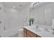 Clean bathroom featuring wood vanity, white toilet, and shower-tub combo with white tiling at 105 Breakers Pl, Cary, NC 27511
