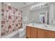 Bathroom featuring a double sink vanity, a shower and tub combo, and gray tile at 105 Breakers Pl, Cary, NC 27511