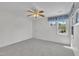 Bright bedroom with a ceiling fan, neutral carpet, and window with patterned valance at 105 Breakers Pl, Cary, NC 27511