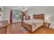 Bright bedroom featuring a wood frame bed, wood flooring, and large window at 105 Breakers Pl, Cary, NC 27511