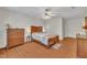 Spacious bedroom featuring hardwood floors, a ceiling fan, and wood furniture at 105 Breakers Pl, Cary, NC 27511