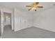 Bedroom featuring neutral carpet, a ceiling fan, and closet with white bi-fold doors at 105 Breakers Pl, Cary, NC 27511
