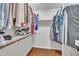 Walk-in closet featuring ample shelving, hanging rods, and hardwood floors at 105 Breakers Pl, Cary, NC 27511