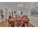 Formal dining room featuring a large table, hardwood floors, and contemporary lighting at 105 Breakers Pl, Cary, NC 27511