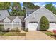 Charming home featuring a one-car garage, gray siding, and beautifully manicured landscaping at 105 Breakers Pl, Cary, NC 27511