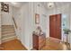 Inviting foyer with hardwood floors, a staircase, and natural light at 105 Breakers Pl, Cary, NC 27511