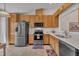 Bright kitchen with stainless steel appliances, light wood cabinets, and neutral countertops at 105 Breakers Pl, Cary, NC 27511