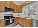Bright kitchen features stainless steel appliances, light wood cabinets and white backsplash at 105 Breakers Pl, Cary, NC 27511