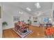 Combined living and dining area with skylights and a clear sight line to a backyard at 105 Breakers Pl, Cary, NC 27511