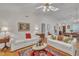 Expansive living area with hardwood flooring, white sofas, and a view of the dining area at 105 Breakers Pl, Cary, NC 27511