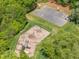 Aerial shot of the community playground and basketball court surrounded by green trees at 105 Breakers Pl, Cary, NC 27511