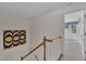 Carpeted stairs with white trim and wood banister, connecting floors in the home at 105 Breakers Pl, Cary, NC 27511