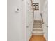 Carpeted stairs with white trim and wooden banister, leading to the next floor at 105 Breakers Pl, Cary, NC 27511