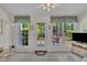 Bright sunroom featuring tile floors, multiple windows, and ceiling fan with lights at 105 Breakers Pl, Cary, NC 27511