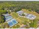 Aerial view of well maintained community tennis courts with mature landscaping and trees at 105 Breakers Pl, Cary, NC 27511