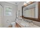 Bright bathroom with vanity, granite countertop, wooden framed mirror, and decorative accents at 107 Candy Apple Ct, Cary, NC 27513