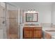 Bright bathroom features a glass door shower, granite countertop vanity, and soaking tub at 107 Candy Apple Ct, Cary, NC 27513