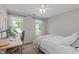 Bedroom with two windows, desk and chair, and plush bed with a cozy throw at 107 Candy Apple Ct, Cary, NC 27513