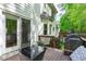 Cozy deck area with outdoor seating and grill, next to a screened door and garden at 107 Candy Apple Ct, Cary, NC 27513