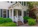 Charming front porch with white railings, brick steps, and lush landscaping at 107 Candy Apple Ct, Cary, NC 27513